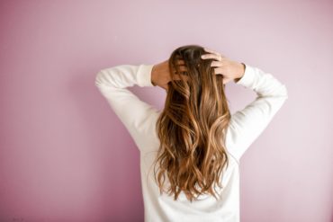 girl pulling her hair back